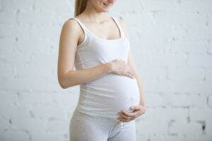 Pregnant young woman. Torso close-up