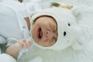 Cute Infant Baby Boy Sleep With Sweet Dream And Peaceful White Soft Bed
